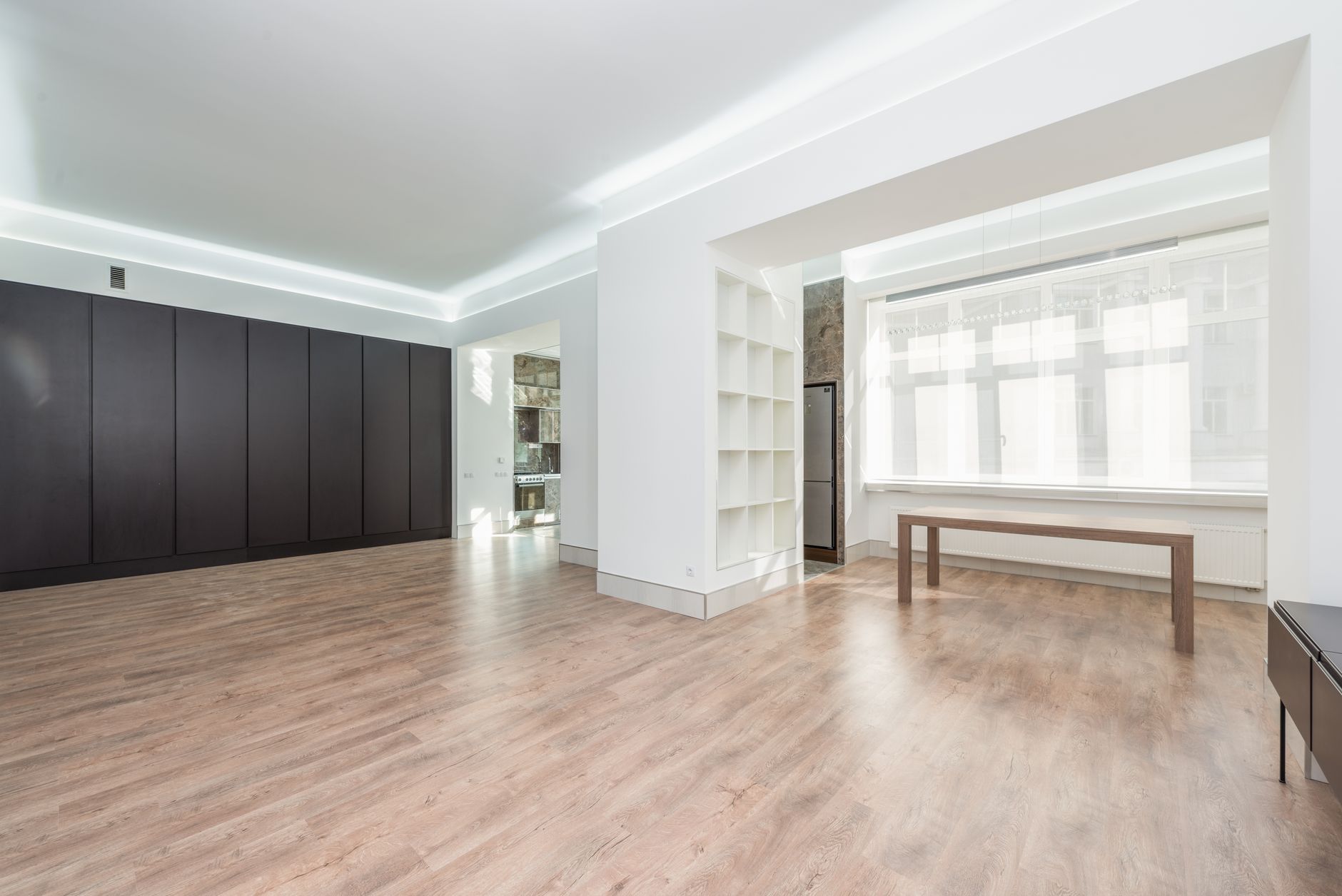 Refinished hardwood flooring in a sunlit empty Colorado room