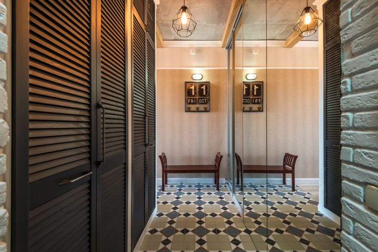 Patterned tile flooring in a Colorado entry hall with a bench